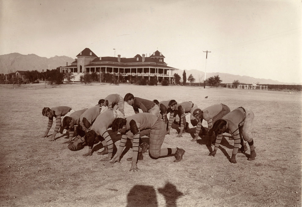 Historical photo of 1902 University of Arizona football team practicing outside Old Main.